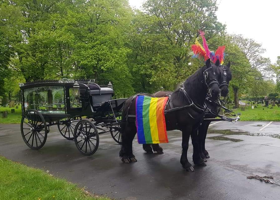 Black horse drawn hearse carriage